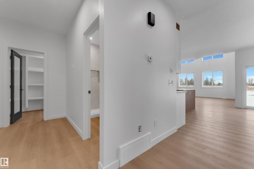 Hall with light wood-style flooring and baseboards - 40 Grayson Green, Stony Plain, AB - Indoor Photo Showing Other Room