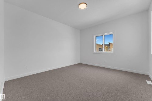 Empty room with light colored carpet and baseboards - 40 Grayson Green, Stony Plain, AB - Indoor Photo Showing Other Room