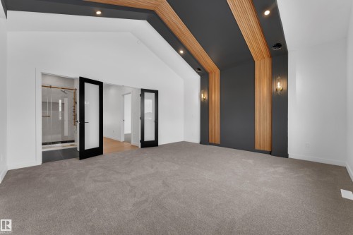 Unfurnished room with french doors, light carpet, vaulted ceiling, and recessed lighting - 40 Grayson Green, Stony Plain, AB - Indoor Photo Showing Other Room
