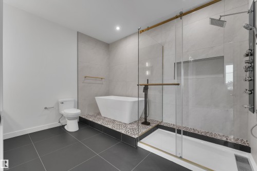 Bathroom featuring a shower stall, a soaking tub, dark tile patterned flooring, and recessed lighting - 40 Grayson Green, Stony Plain, AB - Indoor Photo Showing Bathroom