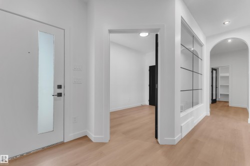 Hallway featuring arched walkways, light wood-style flooring, and recessed lighting - 40 Grayson Green, Stony Plain, AB - Indoor Photo Showing Other Room