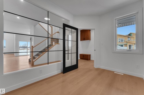 Empty room with stairway and light wood-style flooring - 40 Grayson Green, Stony Plain, AB - Indoor Photo Showing Other Room