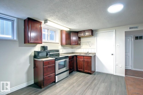 10682 61 Avenue, Edmonton, AB - Indoor Photo Showing Kitchen With Double Sink