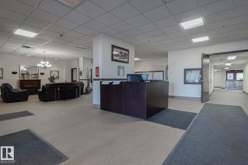 Reception area featuring a drop ceiling and a chandelier - 505 10149 Saskatchewan Drive, Edmonton, AB - Indoor Photo Showing Other Room
