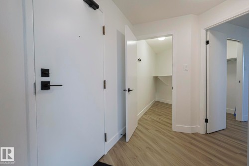 Corridor with light wood-style vinyl plank floors and baseboards - 505 10149 Saskatchewan Drive, Edmonton, AB - Indoor Photo Showing Other Room
