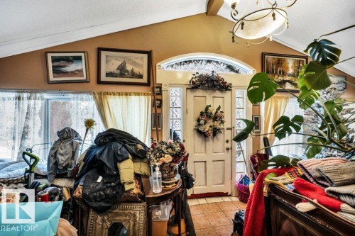 Entryway featuring suspended lighting, vaulted ceiling, and tile patterned floors - 11436 71 Street, Edmonton, AB - Indoor Photo Showing Other Room