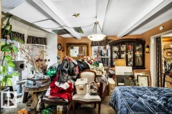 Miscellaneous room featuring a textured ceiling and carpet flooring - 