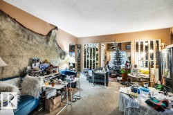 Carpeted living area with a textured ceiling - 