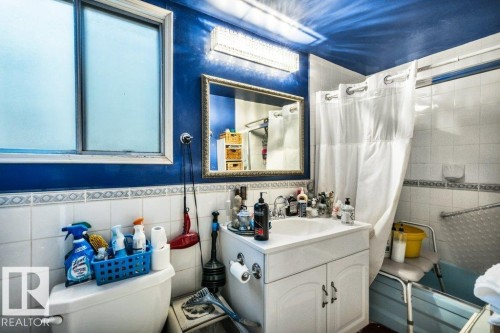 Full bathroom with vanity, tile walls, and a wainscoted wall - 11436 71 Street, Edmonton, AB - Indoor Photo Showing Bathroom
