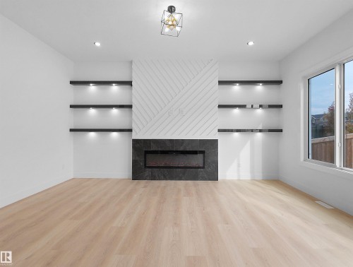 1107 Gyrfalcon Crescent, Edmonton, AB - Indoor Photo Showing Other Room With Fireplace