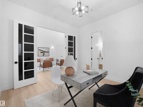 Office area featuring light wood-style floors and suspended lighting - 1168 Gyrfalcon Crescent, Edmonton, AB - Indoor