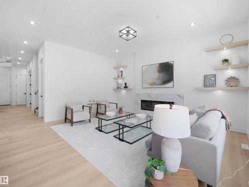 Living area with a premium fireplace, light wood finished floors, and recessed lighting - 1168 Gyrfalcon Crescent, Edmonton, AB - Indoor