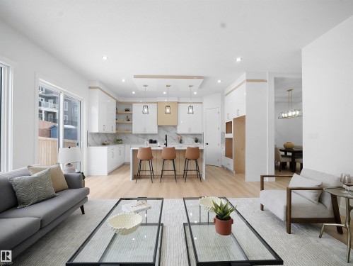 Living room featuring light wood-type flooring and recessed lighting - 1168 Gyrfalcon Crescent, Edmonton, AB - Indoor Photo Showing Living Room
