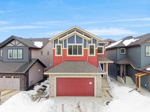 View of front of property with roof with shingles, a garage, and stone siding - 1168 Gyrfalcon Crescent, Edmonton, AB - Outdoor With Facade