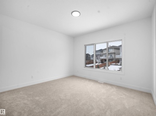 Spare room featuring light colored carpet and baseboards - 1168 Gyrfalcon Crescent, Edmonton, AB - Indoor Photo Showing Other Room