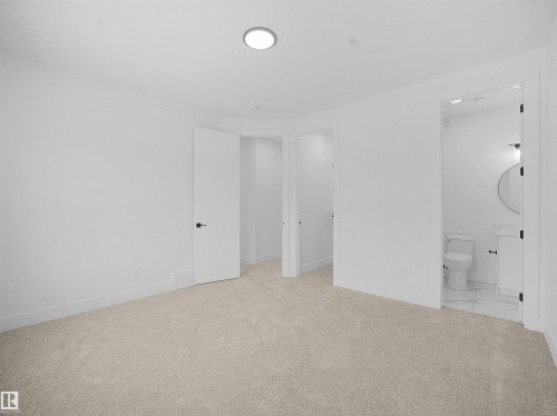 Unfurnished bedroom with light colored carpet and ensuite bath - 1168 Gyrfalcon Crescent, Edmonton, AB - Indoor Photo Showing Other Room