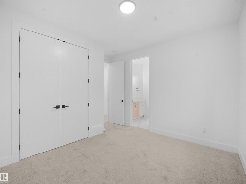 Unfurnished bedroom featuring light colored carpet and a closet - 1168 Gyrfalcon Crescent, Edmonton, AB - Indoor Photo Showing Other Room