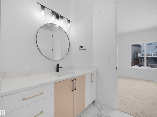 Bathroom featuring vanity, light marble finish flooring, and light carpet - 1168 Gyrfalcon Crescent, Edmonton, AB - Indoor Photo Showing Bathroom