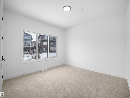 Spare room with light colored carpet and baseboards - 1168 Gyrfalcon Crescent, Edmonton, AB - Indoor Photo Showing Other Room