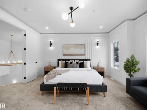 Bedroom featuring carpet flooring, a decorative wall, crown molding, and a chandelier - 1168 Gyrfalcon Crescent, Edmonton, AB - Indoor Photo Showing Bedroom