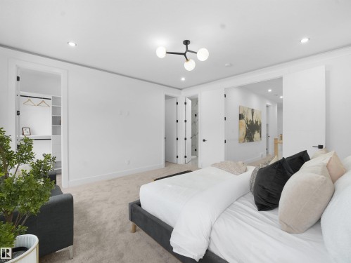 Carpeted bedroom featuring a walk in closet, recessed lighting, and ensuite bathroom - 1168 Gyrfalcon Crescent, Edmonton, AB - Indoor Photo Showing Bedroom