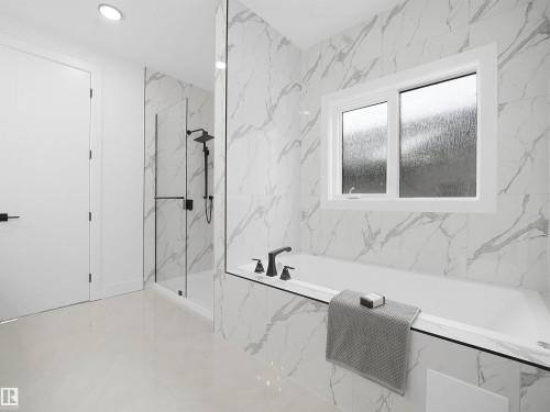 Full bath featuring a garden tub, a marble finish shower, and tile walls - 1168 Gyrfalcon Crescent, Edmonton, AB - Indoor Photo Showing Bathroom