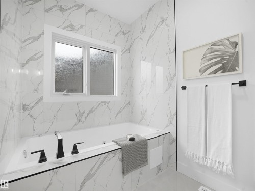 Bathroom with a garden tub and tile walls - 1168 Gyrfalcon Crescent, Edmonton, AB - Indoor Photo Showing Bathroom
