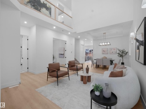 Living area with wood finished floors, recessed lighting, and a high ceiling - 1168 Gyrfalcon Crescent, Edmonton, AB - Indoor