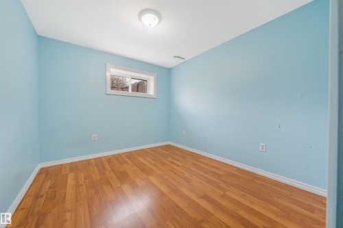 Empty room with hardwood / wood-style flooring and baseboards - 2831 36 Street, Edmonton, AB - Indoor Photo Showing Other Room