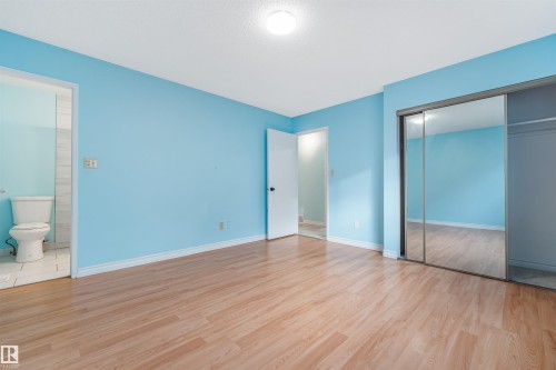 Unfurnished bedroom with light wood-style flooring, a closet, and connected bathroom - 2831 36 Street, Edmonton, AB - Indoor Photo Showing Other Room