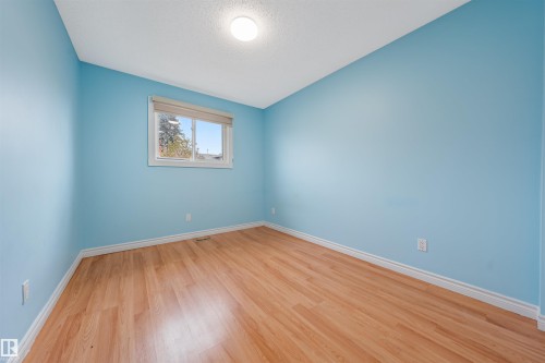 Spare room with light wood-style flooring and a textured ceiling - 2831 36 Street, Edmonton, AB - Indoor Photo Showing Other Room