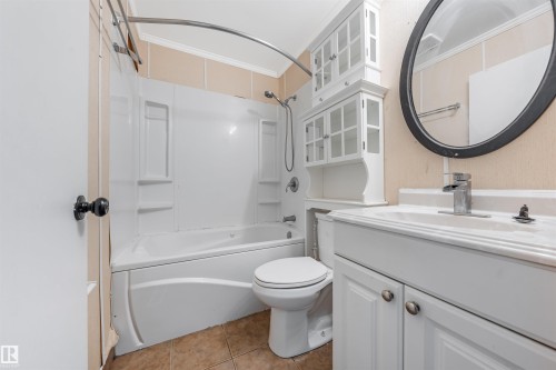 Bathroom with shower / washtub combination, vanity, and light tile patterned floors - 2831 36 Street, Edmonton, AB - Indoor Photo Showing Bathroom