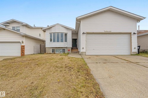 View of front of property with concrete driveway, a garage, and a front lawn - 2831 36 Street, Edmonton, AB - Outdoor