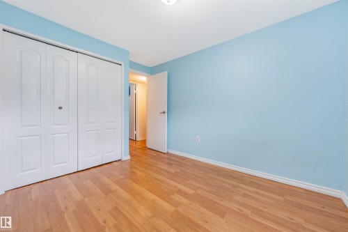 Unfurnished bedroom featuring light wood-type flooring and a closet - 2831 36 Street, Edmonton, AB - Indoor Photo Showing Other Room