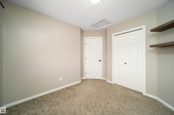 Unfurnished bedroom with carpet flooring, a textured ceiling, and a closet - 