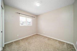 Unfurnished bedroom with a closet, carpet flooring, and a textured ceiling - 