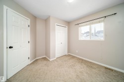 Unfurnished bedroom with carpet flooring, a closet, and a textured ceiling - 