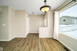 Unfurnished room featuring a textured ceiling and dark wood-style floors - 