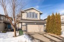 View of front facade with stone siding, an attached garage, concrete driveway, and roof with shingles - 192 Keyport Circle, Leduc, AB  - Outdoor With Facade 