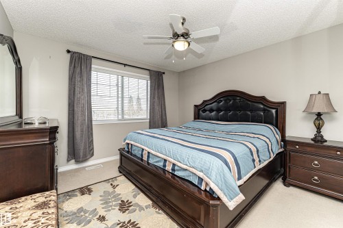 Bedroom featuring light carpet, a textured ceiling, and ceiling fan - 192 Keyport Circle, Leduc, AB - Indoor Photo Showing Bedroom