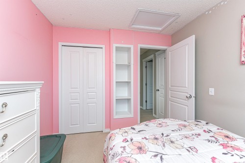 Bedroom with a textured ceiling, light colored carpet, and a closet - 192 Keyport Circle, Leduc, AB - Indoor Photo Showing Bedroom