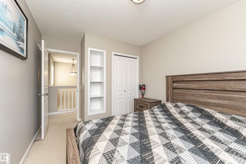 Bedroom featuring a textured ceiling, light colored carpet, and a closet - 192 Keyport Circle, Leduc, AB - Indoor Photo Showing Bedroom