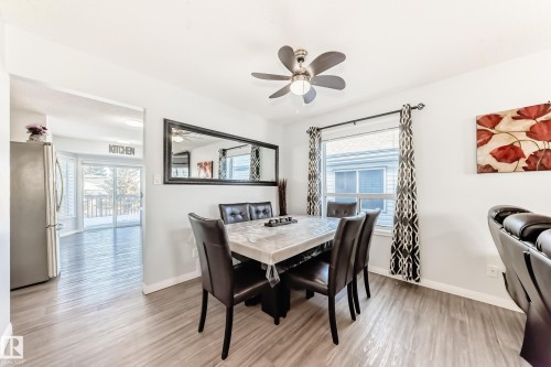 Dining space with plenty of natural light, light wood finished floors, and a ceiling fan - 6 Jefferson Road, Edmonton, AB 