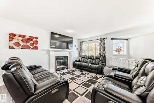 Living area featuring a tiled fireplace - 6 Jefferson Road, Edmonton, AB 