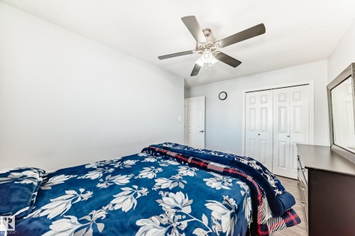 Bedroom with a ceiling fan, a closet, and wood finished floors - 6 Jefferson Road, Edmonton, AB 