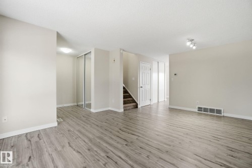 Spare room with light wood-style floors and a textured ceiling - 8006 15A Avenue, Edmonton, AB - Indoor