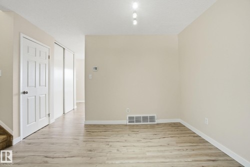 Spare room with light wood-type flooring and a textured ceiling - 8006 15A Avenue, Edmonton, AB - Indoor Photo Showing Other Room