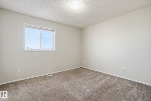 Empty room featuring a textured ceiling and carpet - 8006 15A Avenue, Edmonton, AB - Indoor Photo Showing Other Room