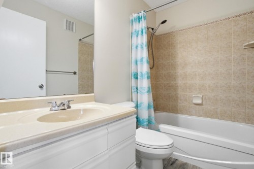 Bathroom with vanity, shower / tub combo, and a textured ceiling - 8006 15A Avenue, Edmonton, AB - Indoor Photo Showing Bathroom