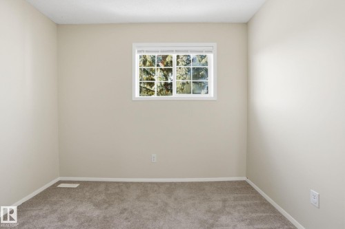 Empty room with light colored carpet and baseboards - 8006 15A Avenue, Edmonton, AB - Indoor Photo Showing Other Room